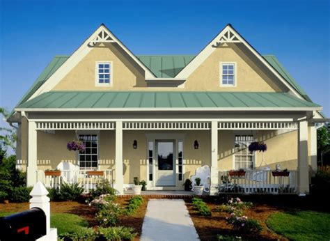 brick house with green metal roof and yellow door|house with green roof colors.